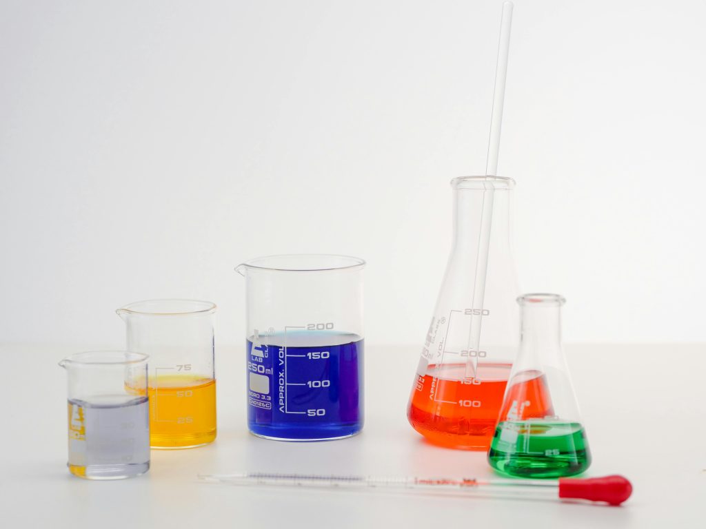 Laboratory glassware with colorful liquids, ideal for science and research themes.